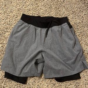 Grey and black athletic shorts with built in compression shorts